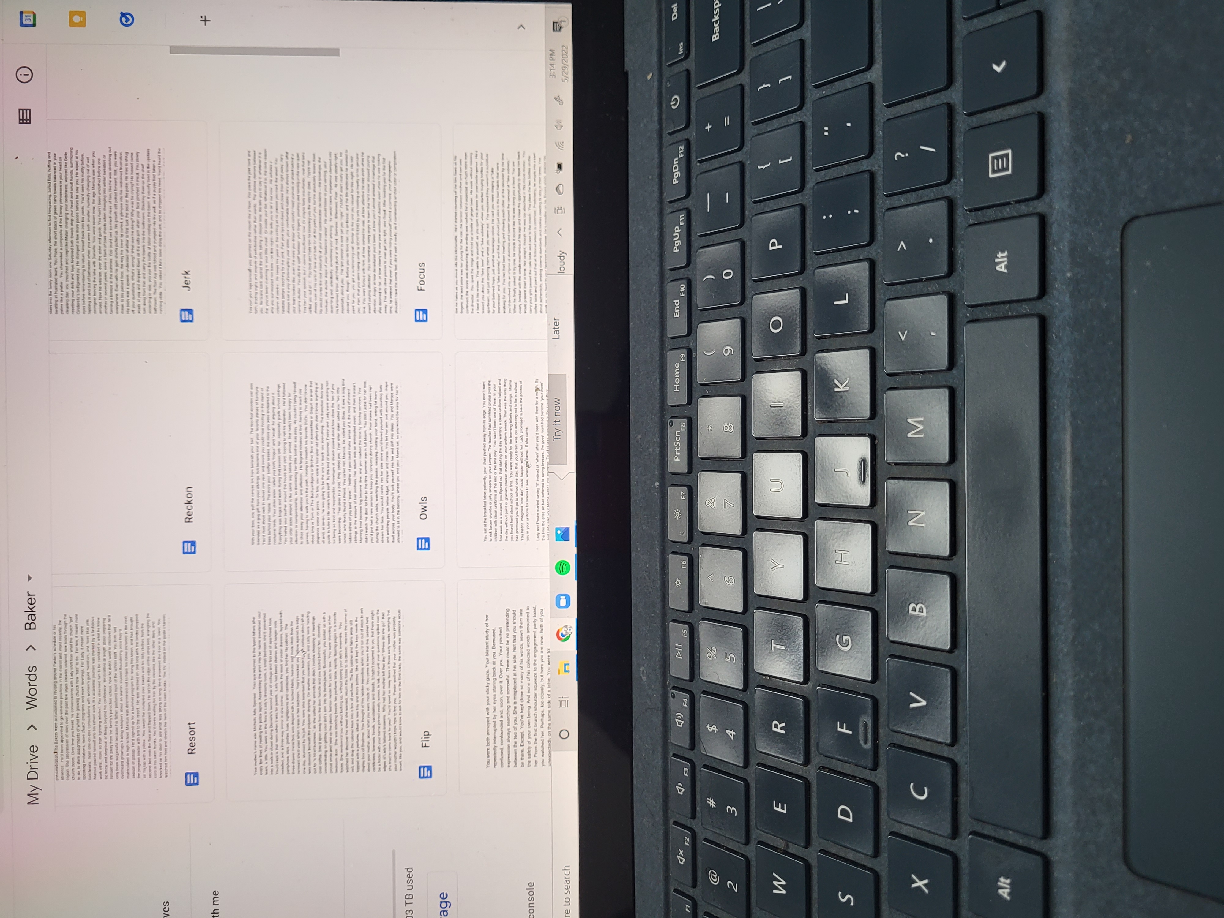 Pages on laptop screen, keyboard visible